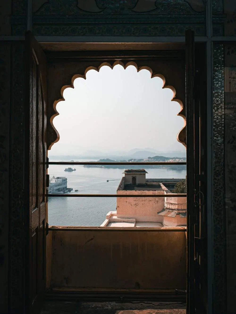 A cusped jharokha window at the City Palace, Udaipur, looking out over the lake