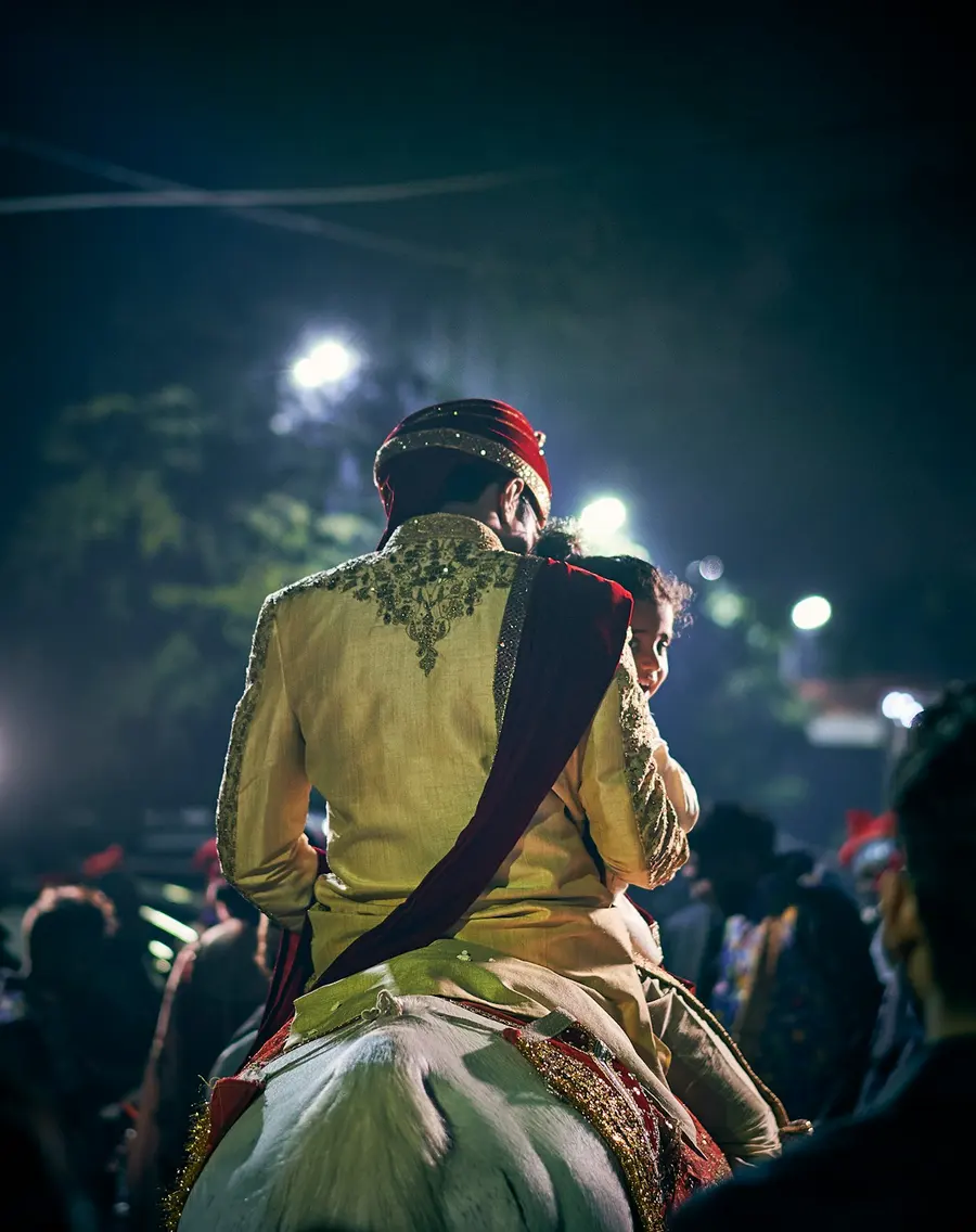 The groom on the ghodi at the baraat, at night