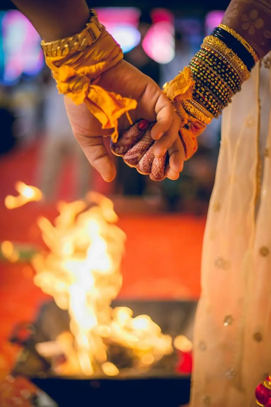 The couple's hands over the sacred fire